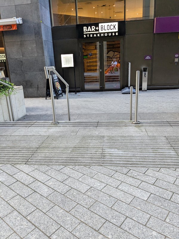 Image of stairs leading to Bar+Block next to the hotel entrance