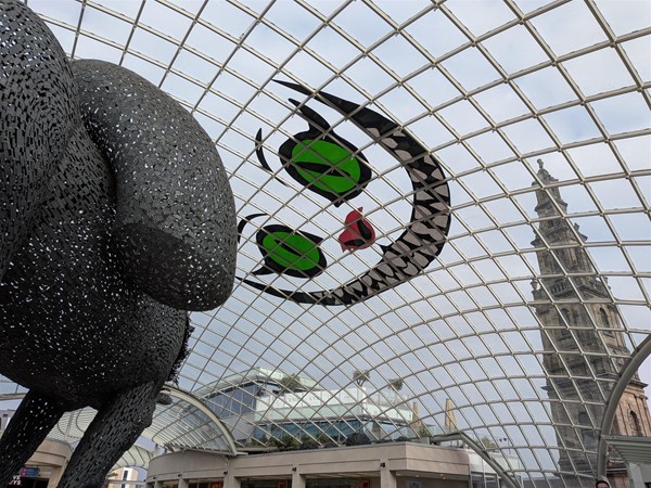 image of the glass roof, horse statue, grinning cat decal and Trinity Church beyond