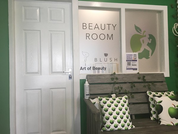 Image of the outside the outside of Art of Beauty's treatment room showing the door entrance.
