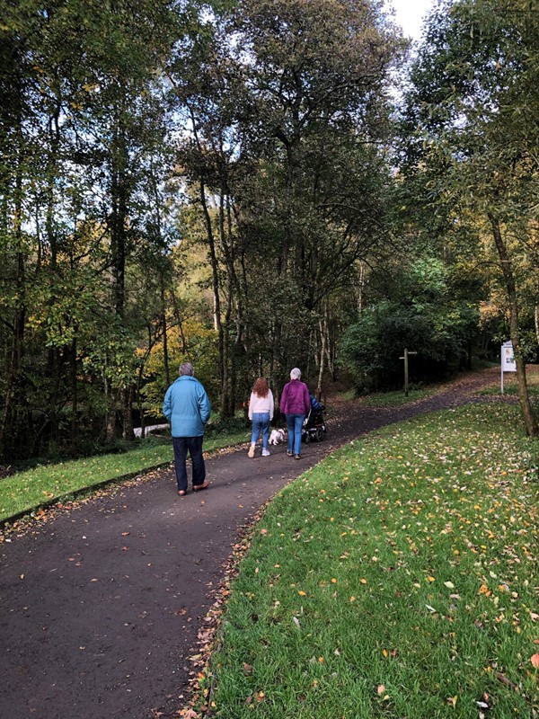 People walking down a wide path.