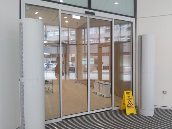 Picture of a sliding door with a yellow cone outside