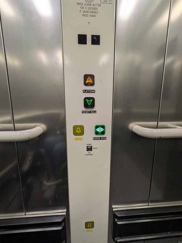 Image of lift buttons. The lift buttons have braille markings