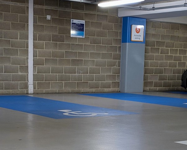Image of accessible parking spaces with bays on the floor painted blue