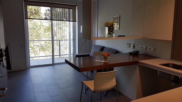 Living area with access to private balcony.