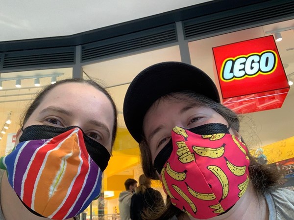 Picture of people in masks outside the Lego store