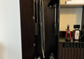Image shows the interior of a wardrobe in an accessible room at The Grand Hotel in Birmingham. The rail is at standard height but can be pulled down to a lower position by using a handle inside the wardrobe. Some people may require assistance with this. 
There is also an iron and ironing board stored in the wardrobe.