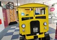 Picture of a yellow bus made of wood
