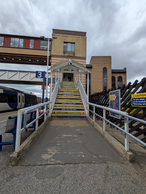 Image of stairs with rails leading up to the bridge
