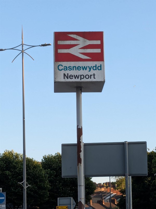 Image of a pole with signage for Newport Station