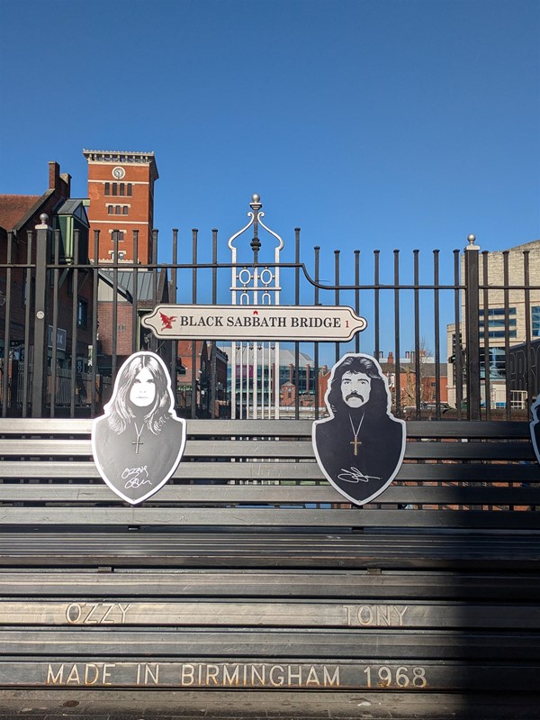 Image of metal bench on Black Sabbath Bridge showing all Ozzy and Tony and their signatures