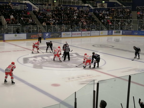 Image of a hockey game on the ice