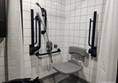 Shower and shower chair with fold away rails available in the accessible toilet
