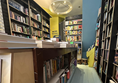 Image of narrow path between two bookshelves