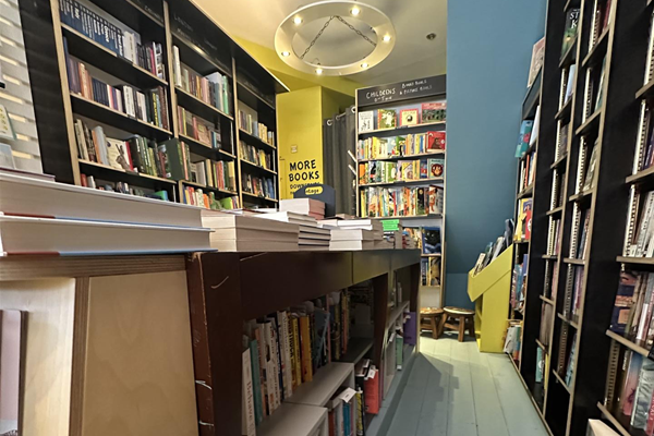 Image of narrow path between two bookshelves