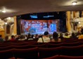 View from the wheelchair-accessible seating at the back of the Pavilion Theatre. The stage is visible in the distance with a mostly clear line of sight.