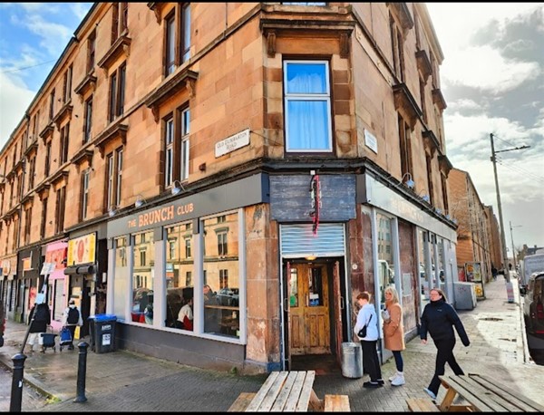 Photo is a panoramic view of the Brunch Club from the street