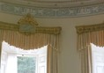 A room with a window and curtains