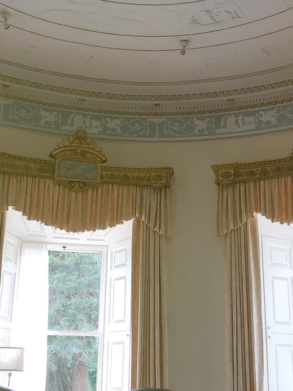A room with a window and curtains