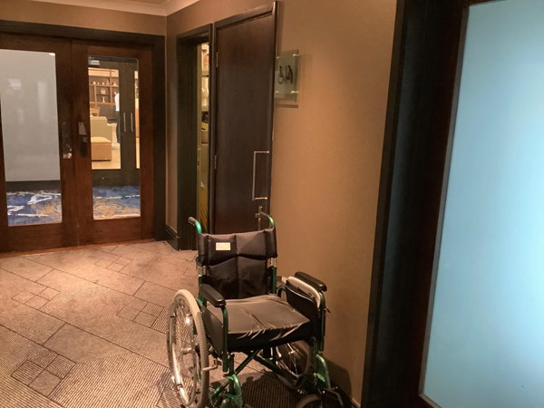 Picture of a wheelchair outside an accessible toilet