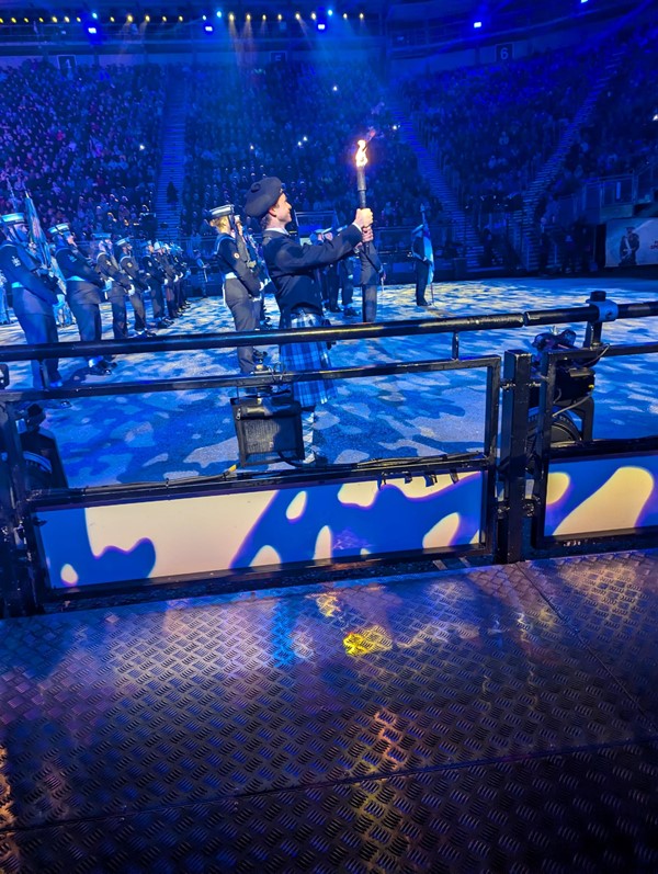 Image of a person in a kilt holding a torch