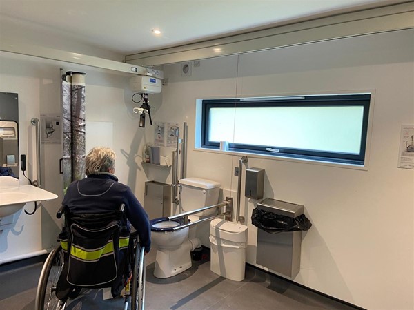 Image of a wheelchair user in an accessible toilet