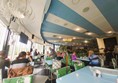Image of a group of people sitting at tables in a restaurant