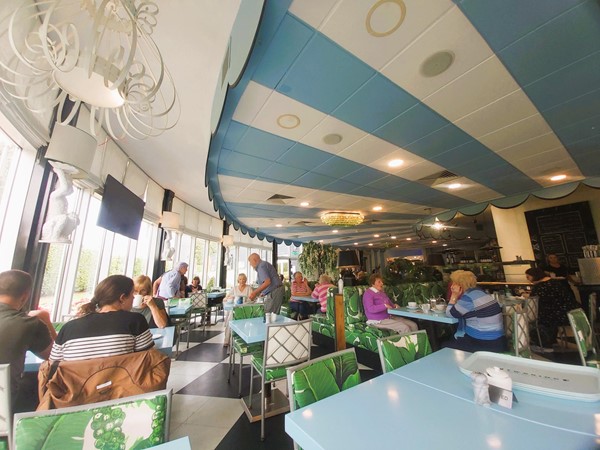 Image of a group of people sitting at tables in a restaurant