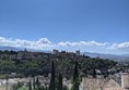 The view from the viewpoint Mirador de San Nicolas over the city, Alhambra and surrounding mountains.