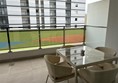 Living room/dining area/ kitchen area looking out onto balcony