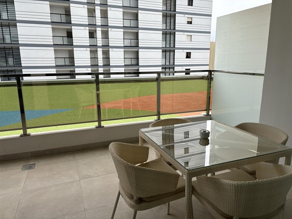 Living room/dining area/ kitchen area looking out onto balcony