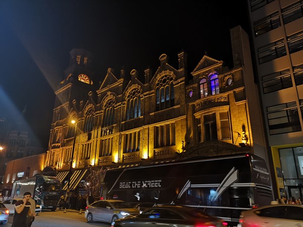 The exterior of Albert Hall Manchester lit up at night.