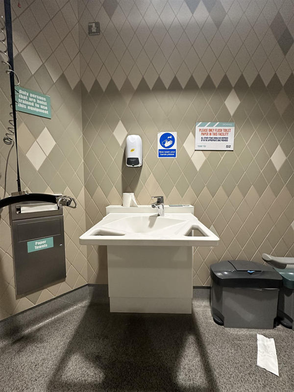 Image of height-adjustable sink and paper towel dispenser