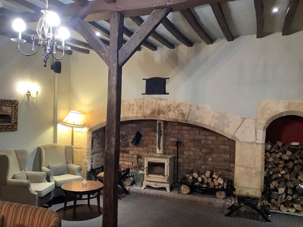 Picture of a lovely open fireplace, with neatly stacked log piles