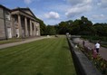 Image of a lawn in front of a building with doric columns.
