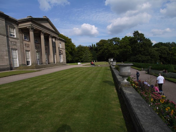 Image of a lawn in front of a building with doric columns.