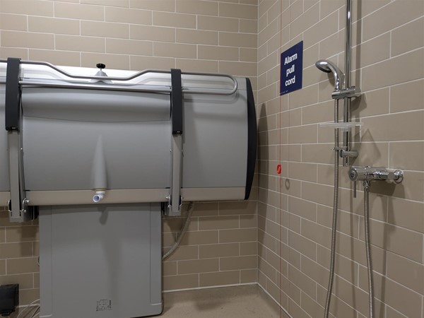 Image of Adjustable change bed and shower in the Changing Places toilet