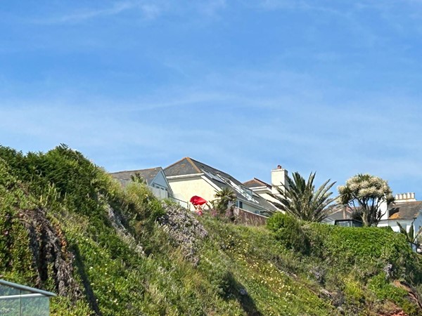 View of cottage from bottom of cliff. My friend waving a red slide sheet!!