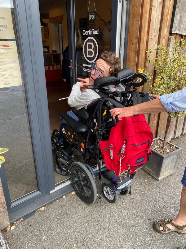 Image of a wheelchair user entering a building
