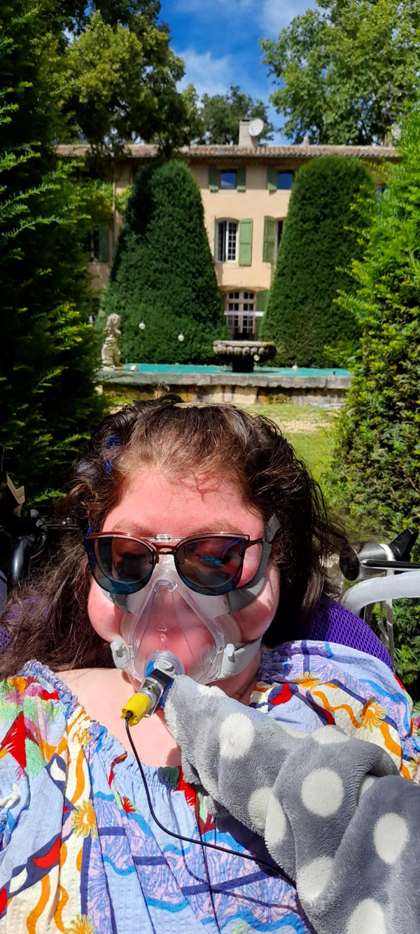 Image of a person in front of a house