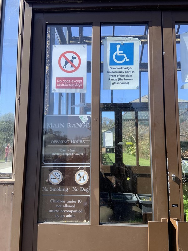 Image of a double door with big rectangular handles and a “pull” sign