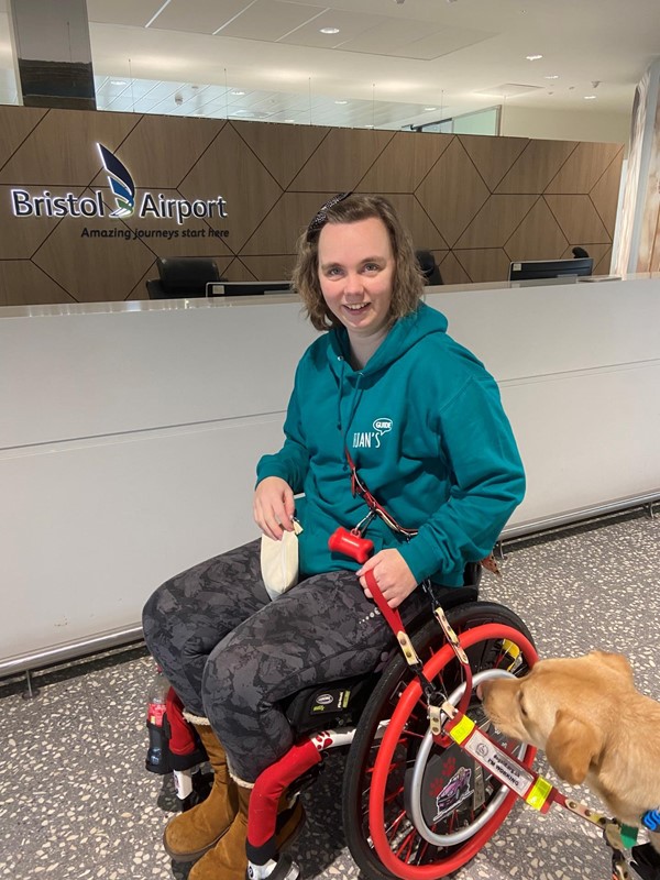 Image of a wheelchair user and assistance dog at Bristol Airport