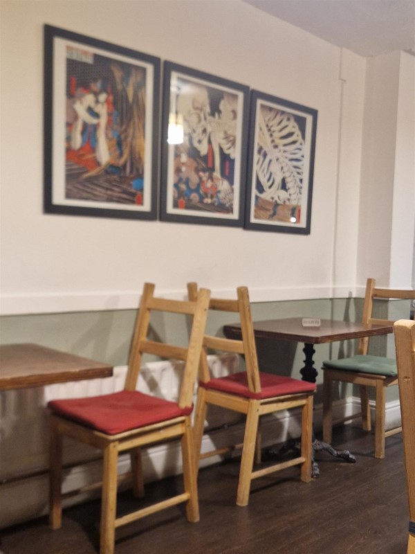 Image of tables, chairs and paintings