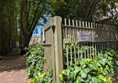 Image of green fence at the entrance to the park