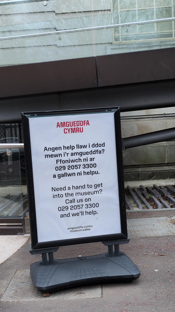Image of signage outside of the museum advising to call 029 2057 3300
