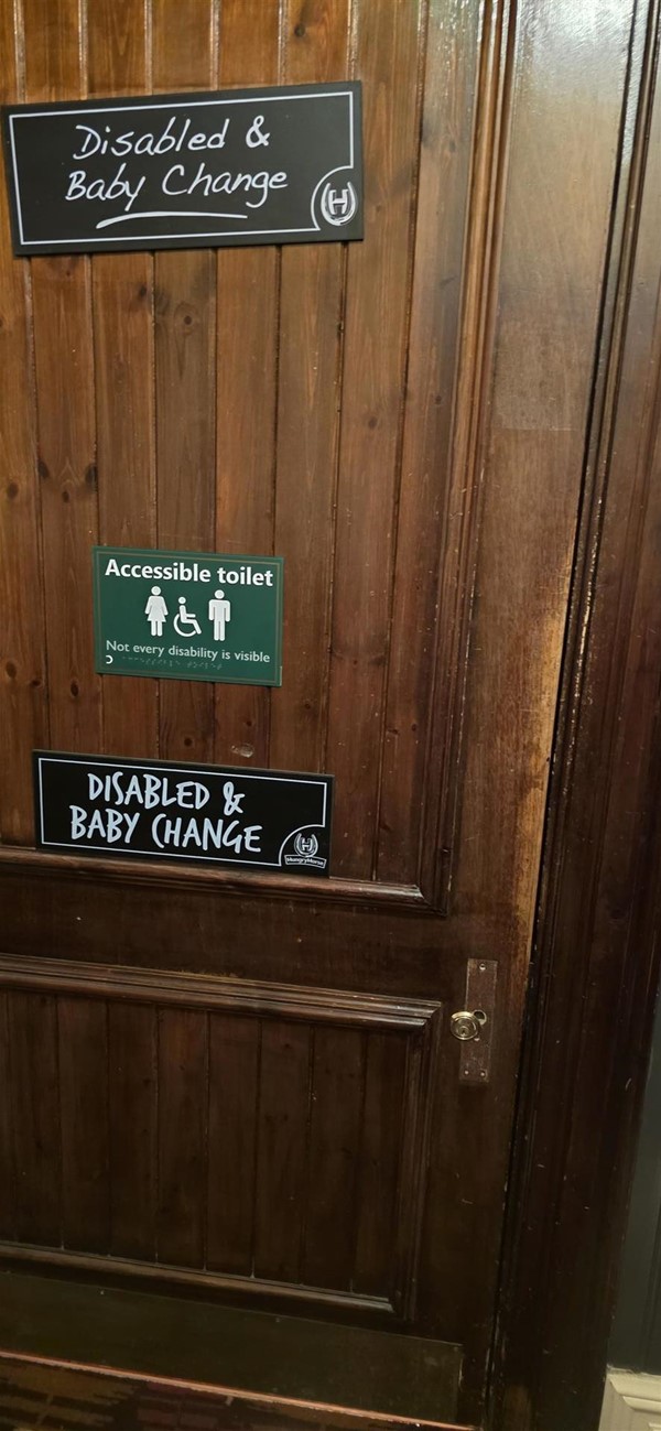Accessible toilet door showing yale lock