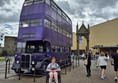 Image of a purple triple decker bus