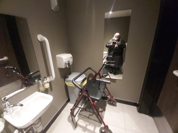 Image of a person standing in a bathroom