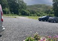 Imag of a planter in a car park with a hill in the background