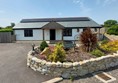 Outside view of the cottage. Plenty of parking and level access into the property