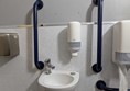 Image of contrasting rails and a small sink with lever-style tap